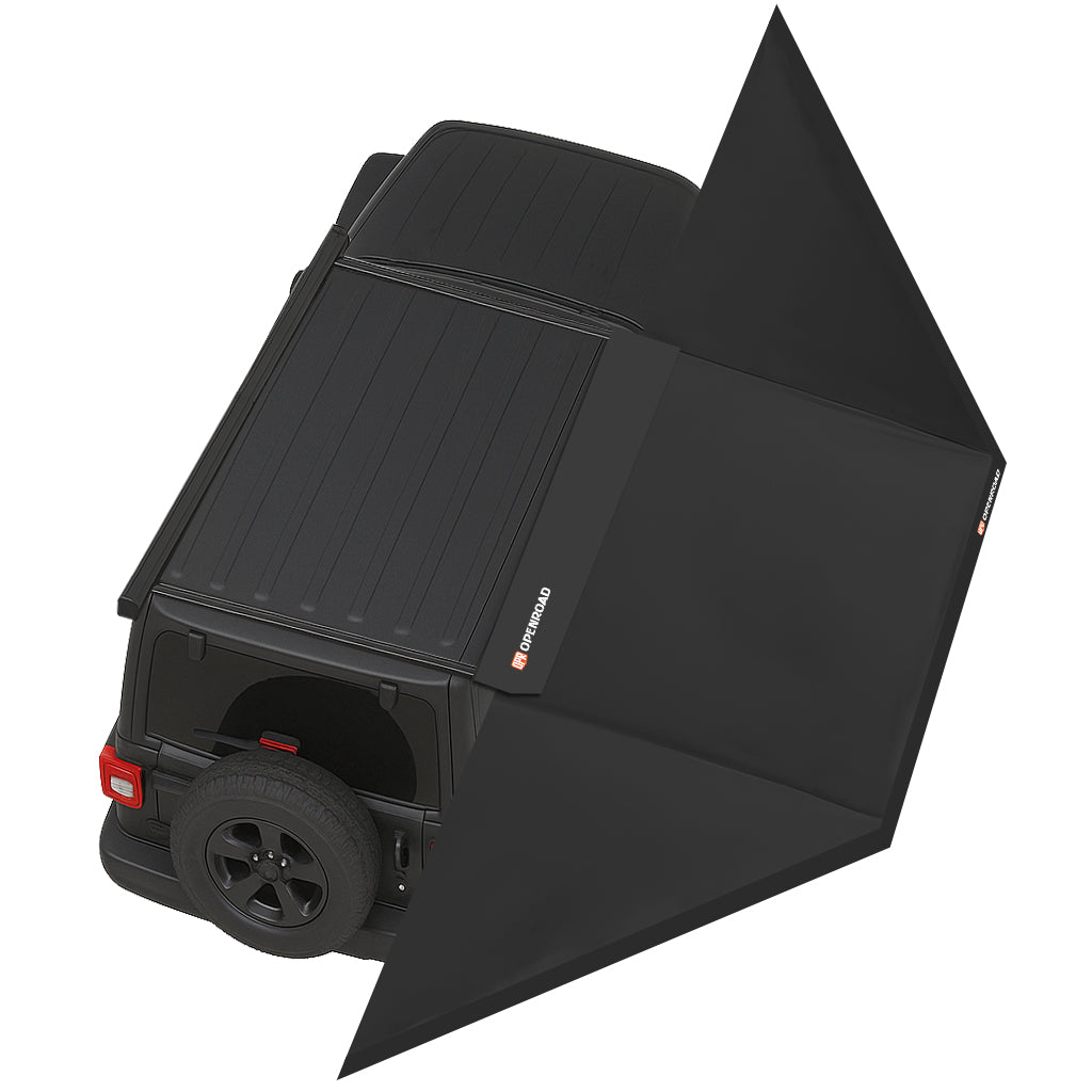 Overhead view of the OpenRoad 270 Freestanding Awning deployed on a 4WD roof rack, shading two camp chairs and an ATV beside a riverbank