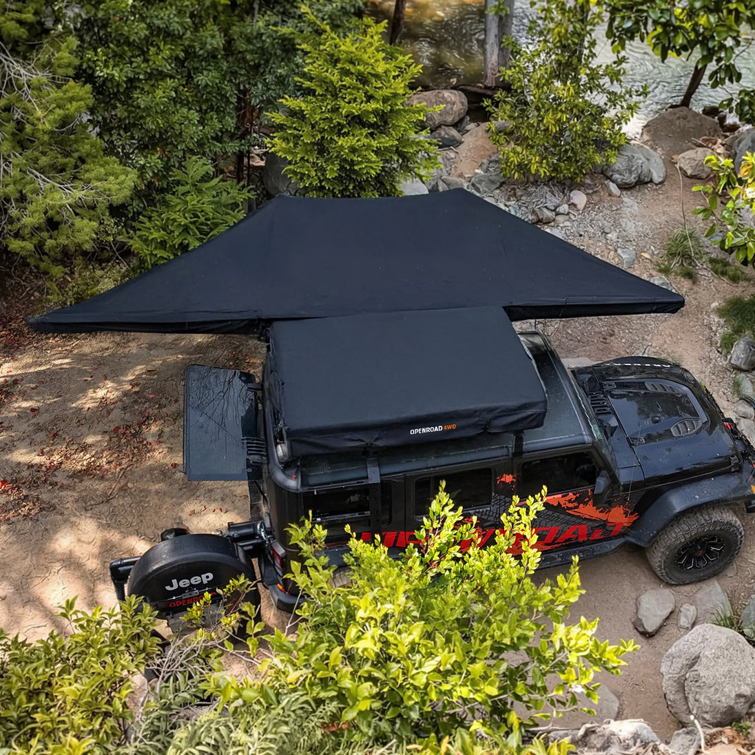 OPENROAD 180 degree awning providing shade and shelter for vehicles and outdoor activities.