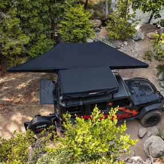 OPENROAD 180 degree awning providing shade and shelter for vehicles and outdoor activities.