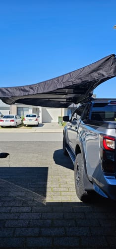 Openroad 270 degree awning mounted on an Isuzu D-Max 4x4 providing wide side and rear shade at camp