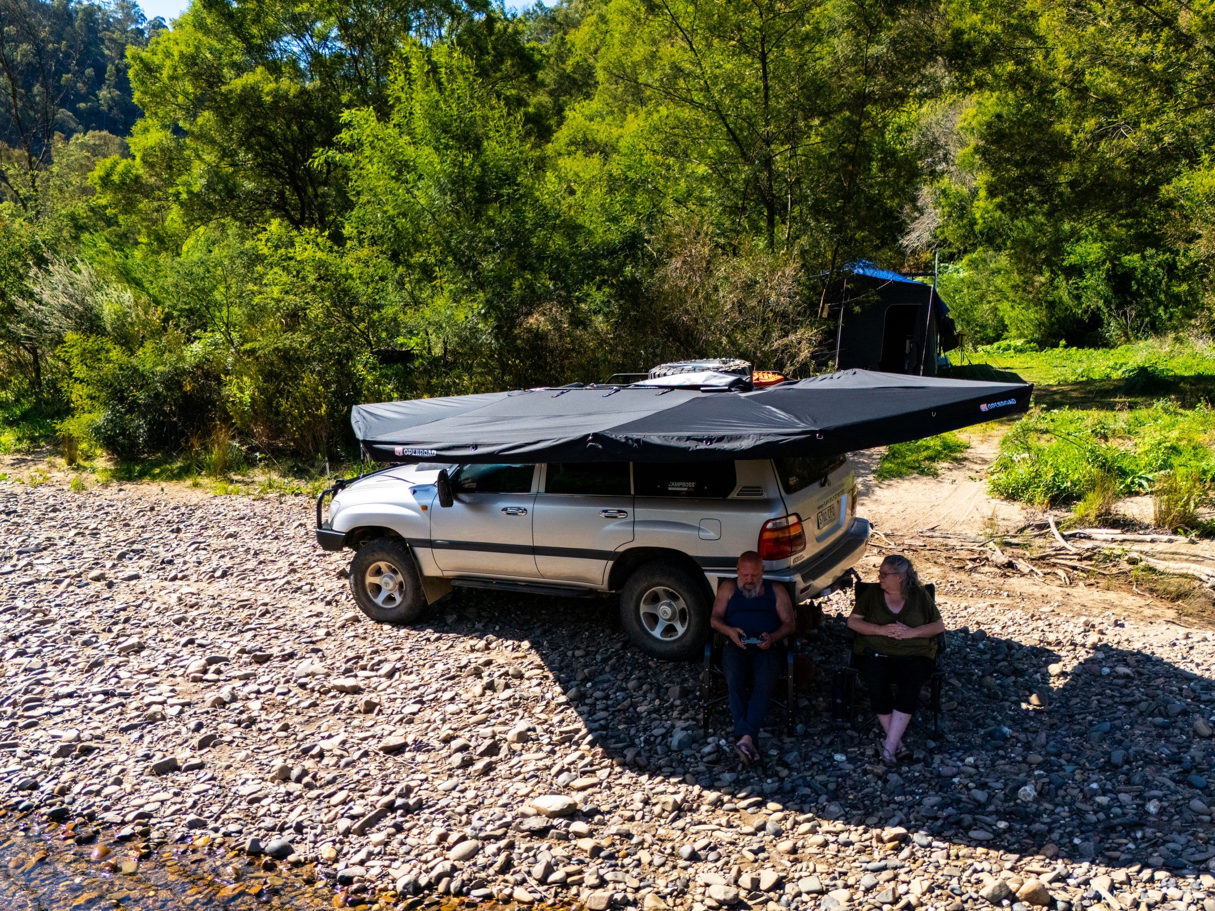 Toyota LandCruiser with OPENROAD 270 awning for car—wrap-around shade by the river
