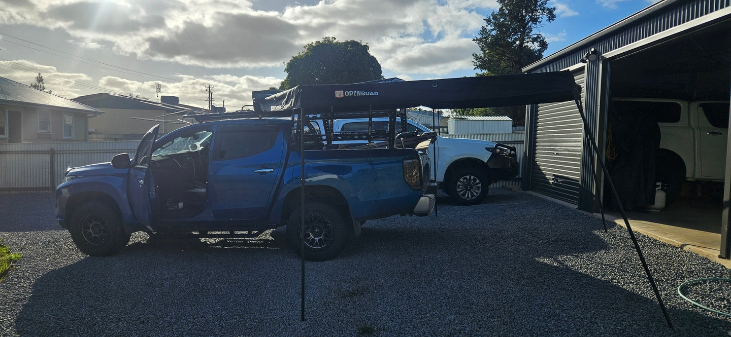 Mitsubishi Triton fitted with an OPENROAD 270 awning, showing a practical 4WD car awning setup in the driveway.