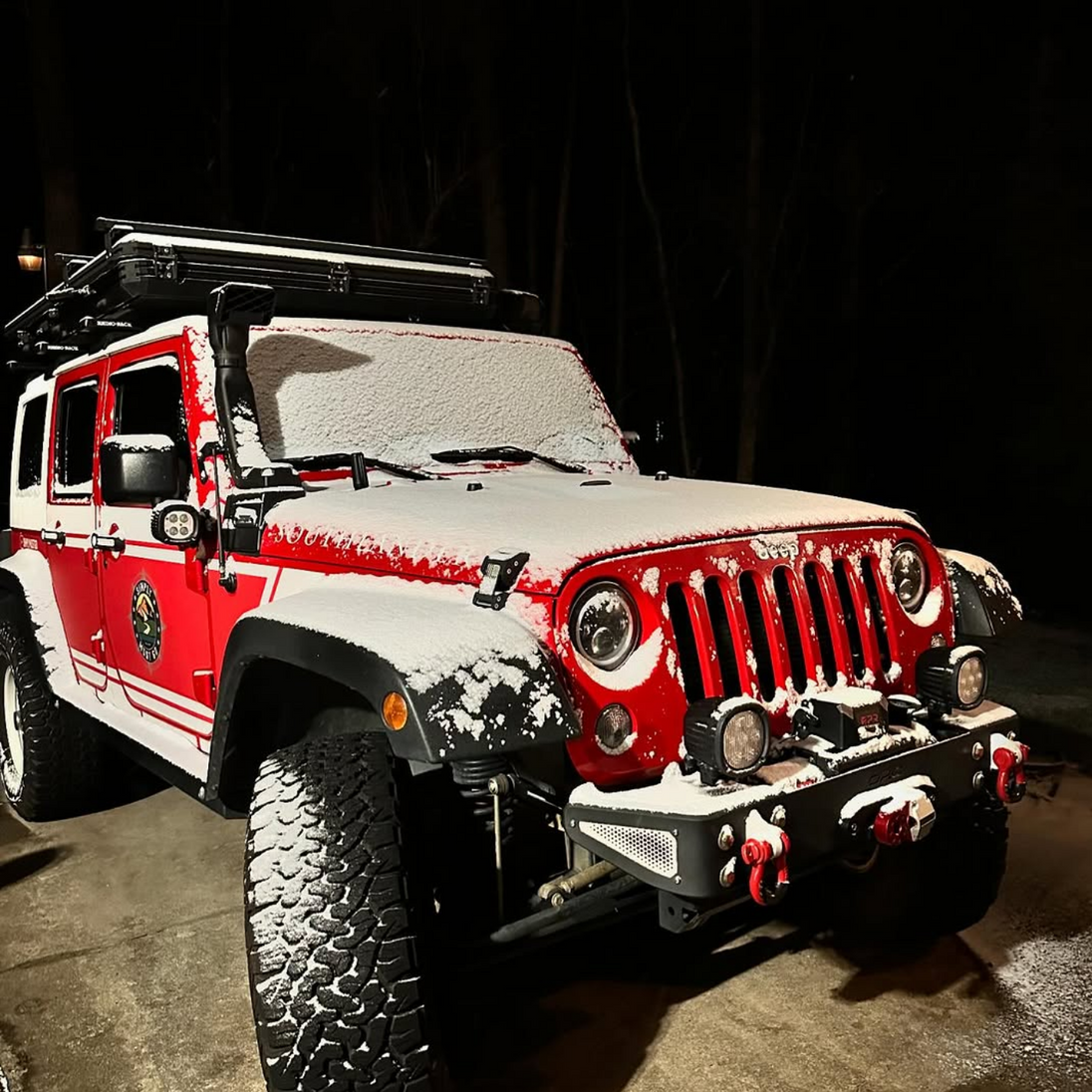 Snow-covered Jeep Wrangler with 4 wheel drive winch and off-road gear, ready for winter recovery and overlanding