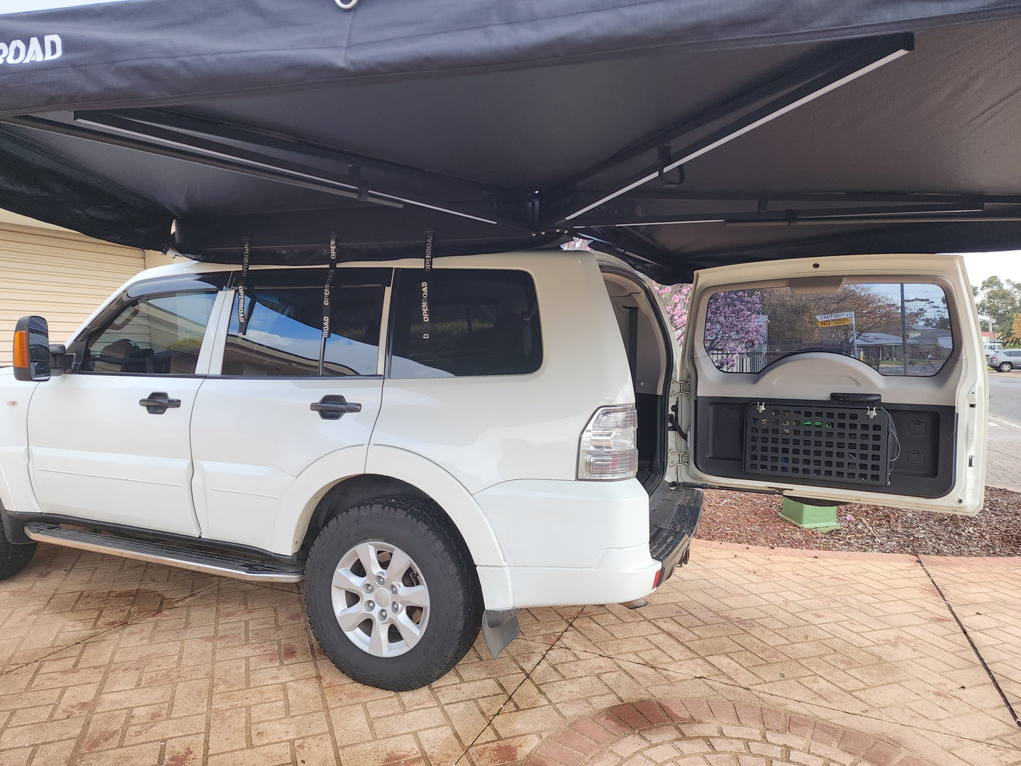 Side view of a Mitsubishi Pajero using a 270 degree side awning for camping shelter