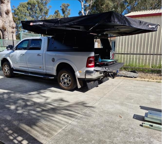 Ram 2500/3500 fitted with an OPENROAD 270 awning, showing a full 4WD awning setup with extended shade for camping