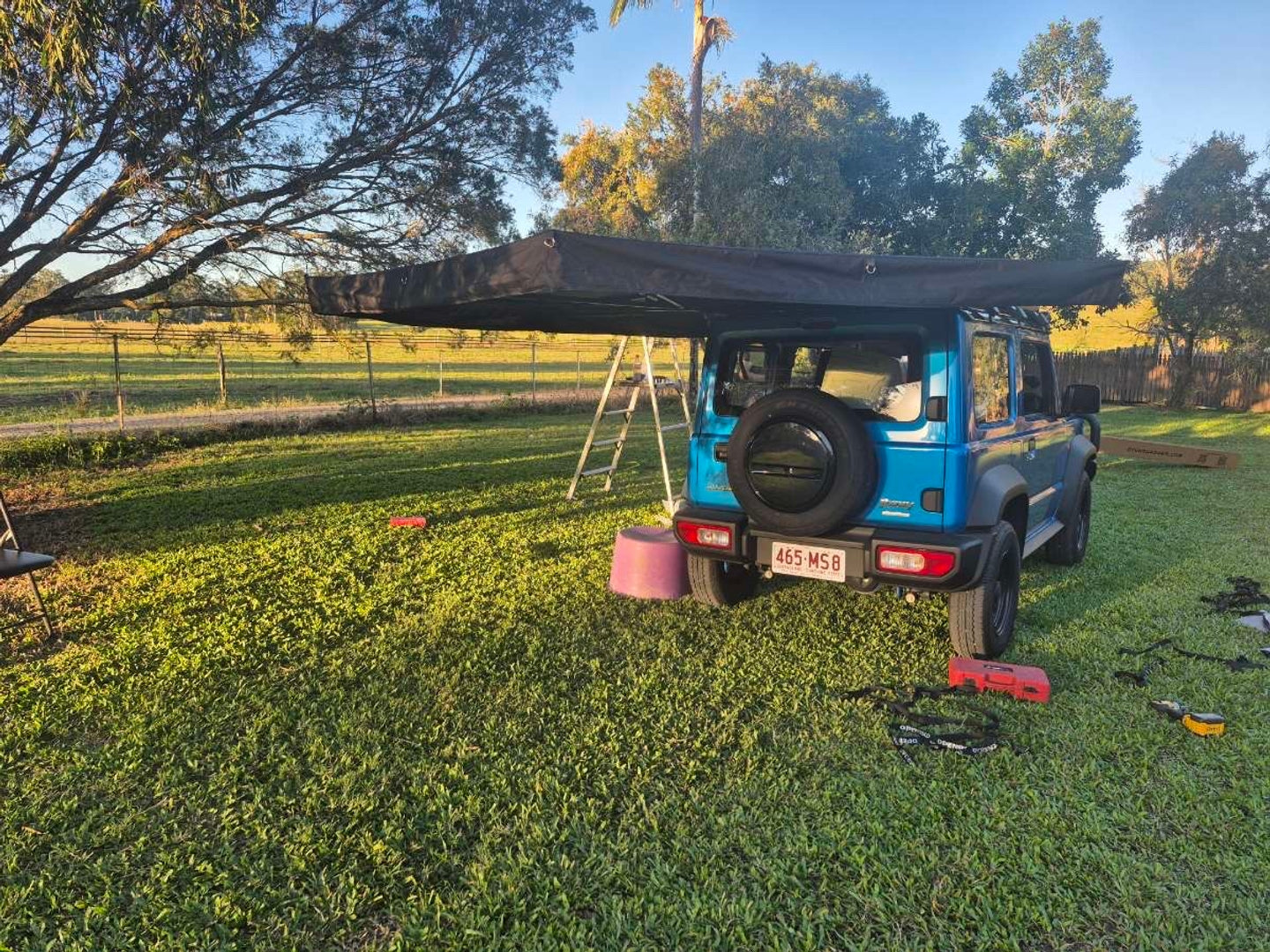 Openroad 270 awning on a Suzuki Jimny, side view with camper setting up car awning tent for camping shade